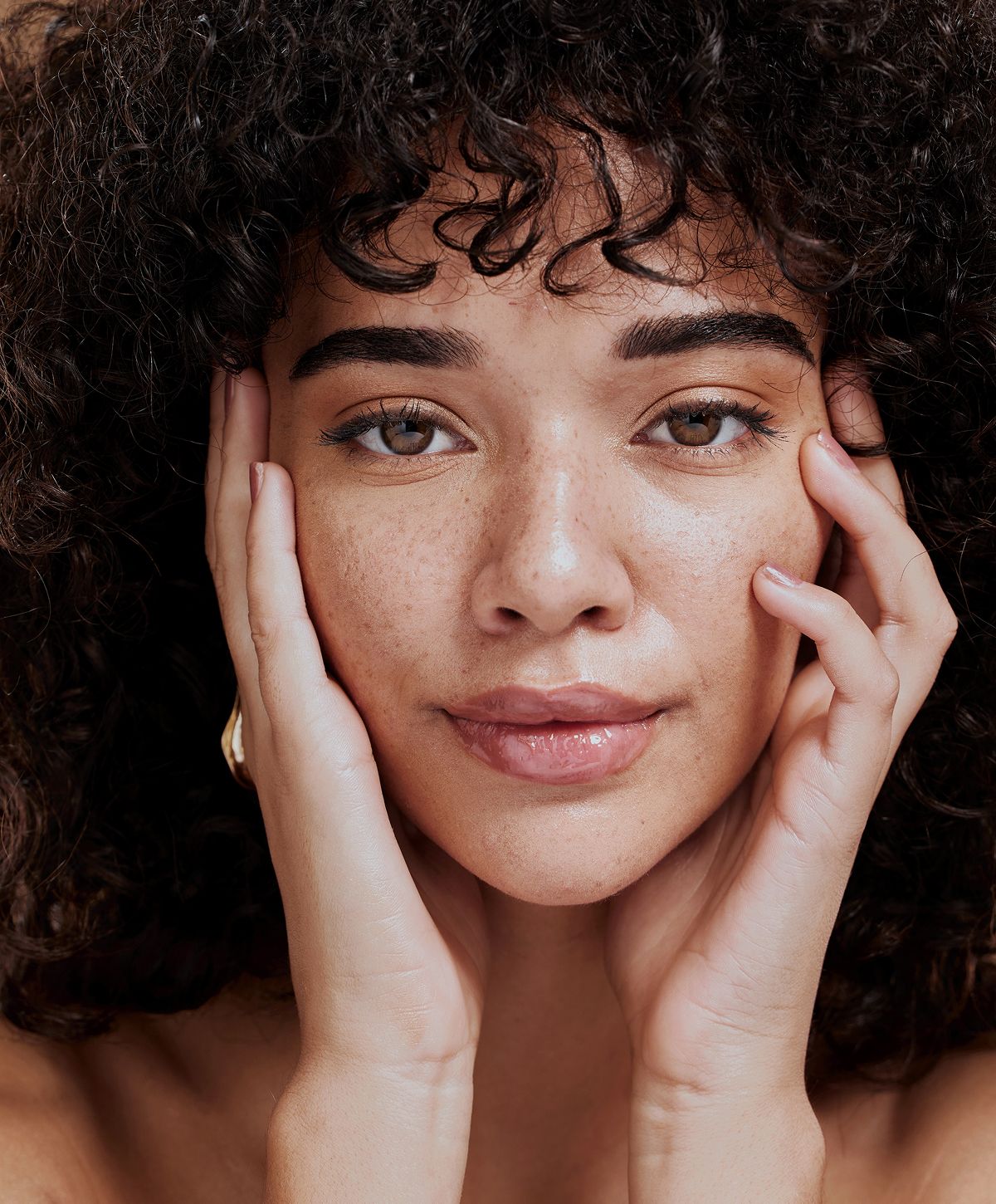 Close-up of a woman with curly hair.