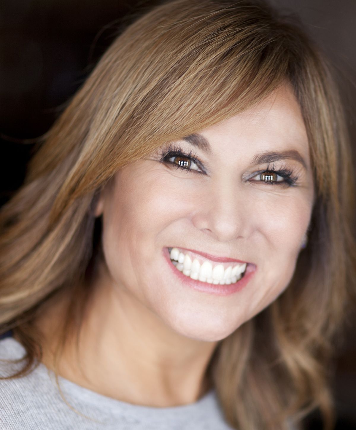 Smiling woman with long brown hair.