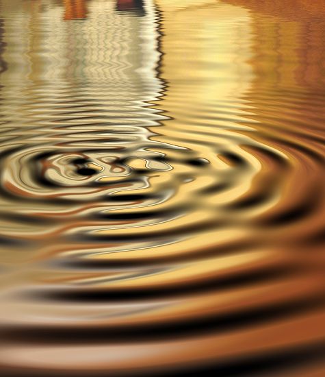 Ripples on water with warm golden reflections.