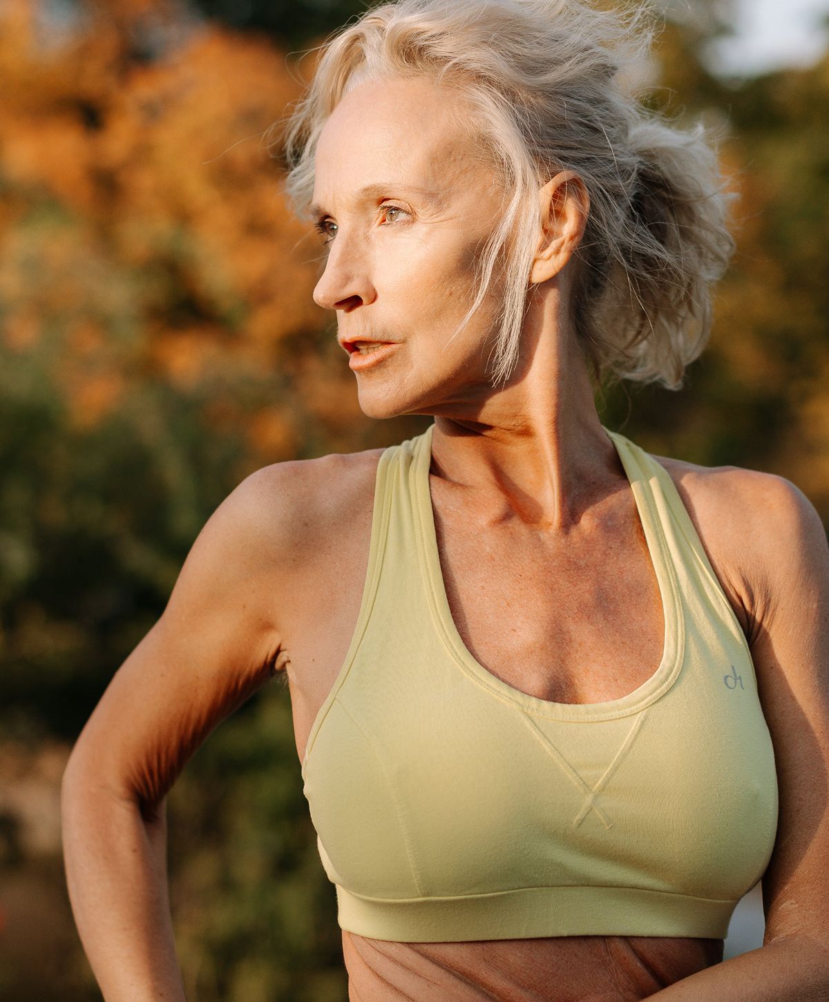 Older woman in workout attire outdoors.