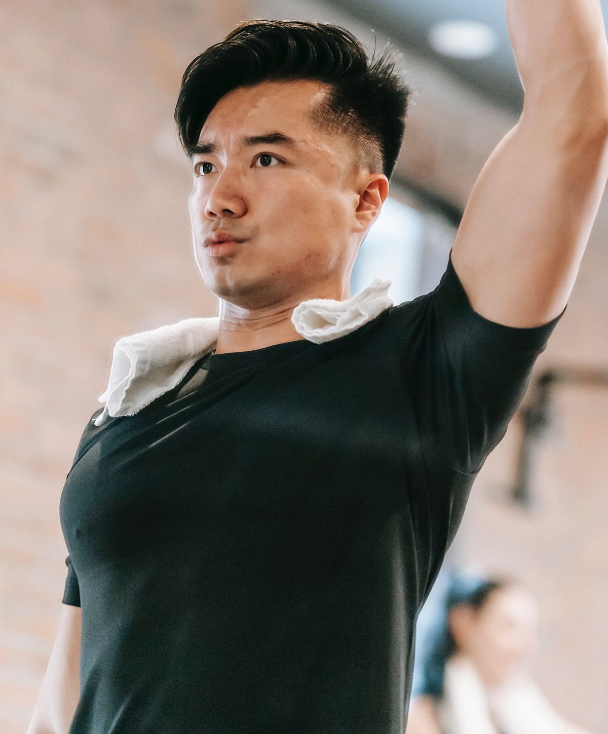 Man exercising with a towel around his neck.