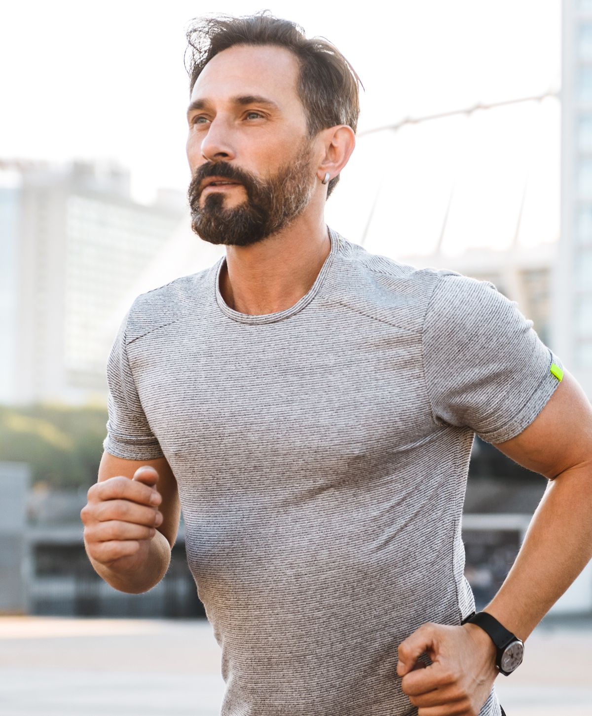 Man jogging outdoors in athletic wear.