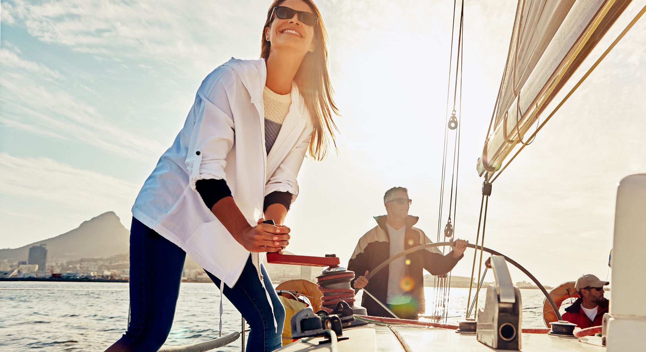 People sailing on a boat during sunset.