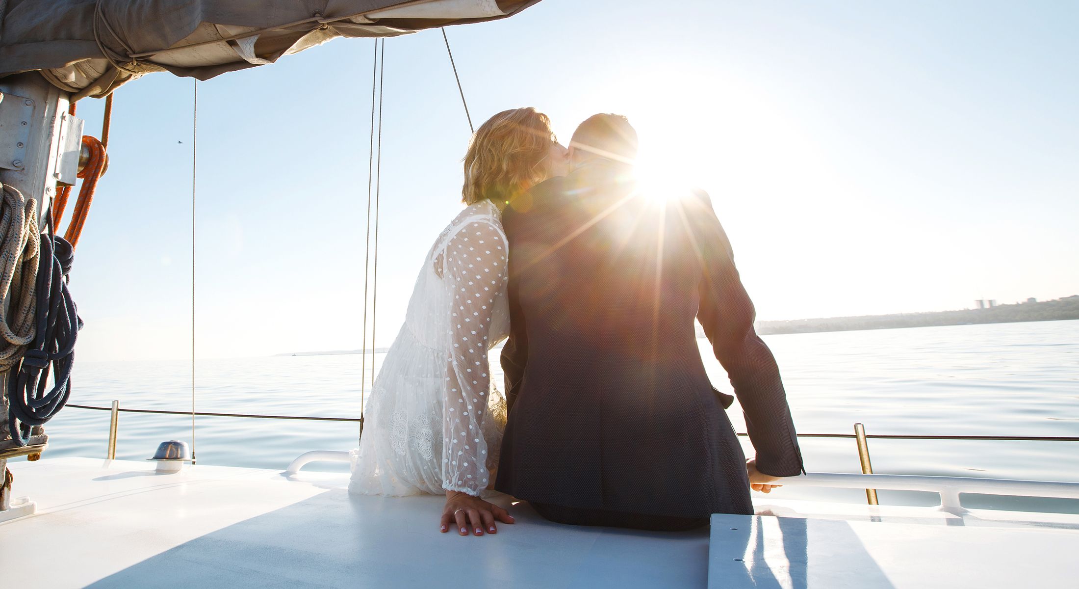 Couple enjoying a sunset on a sailboat.