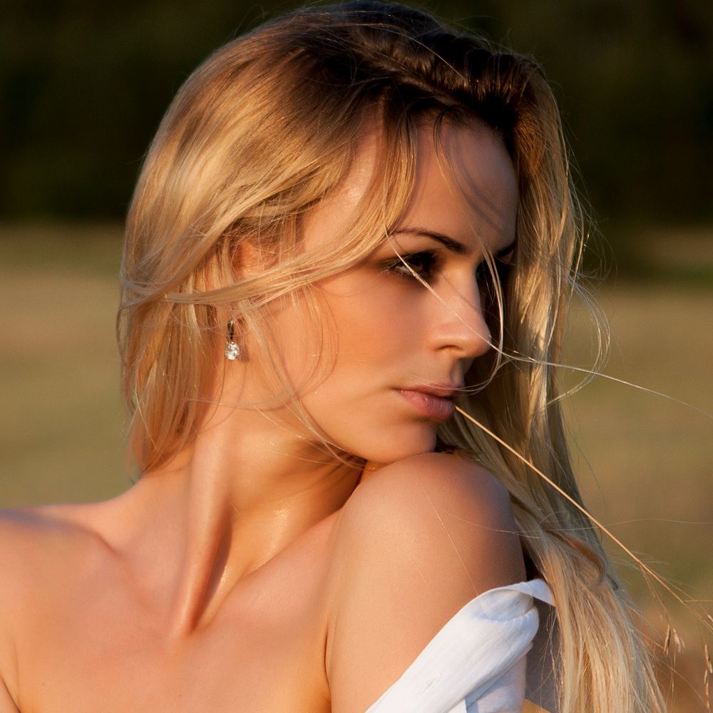 Profile of a woman with flowing blonde hair.