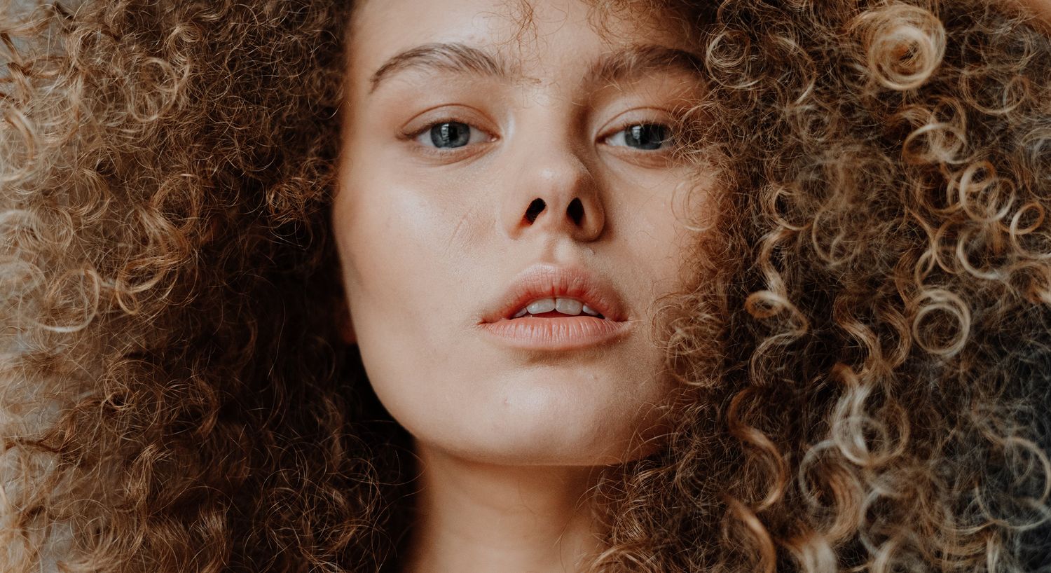 Close-up of a person with curly hair.