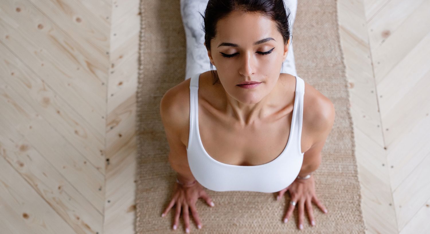 Woman practicing yoga in a serene indoor space.